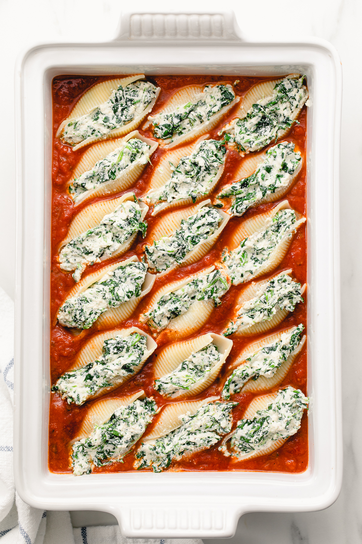 top down view of baking dish with vegan stuffed shells ready for the oven.