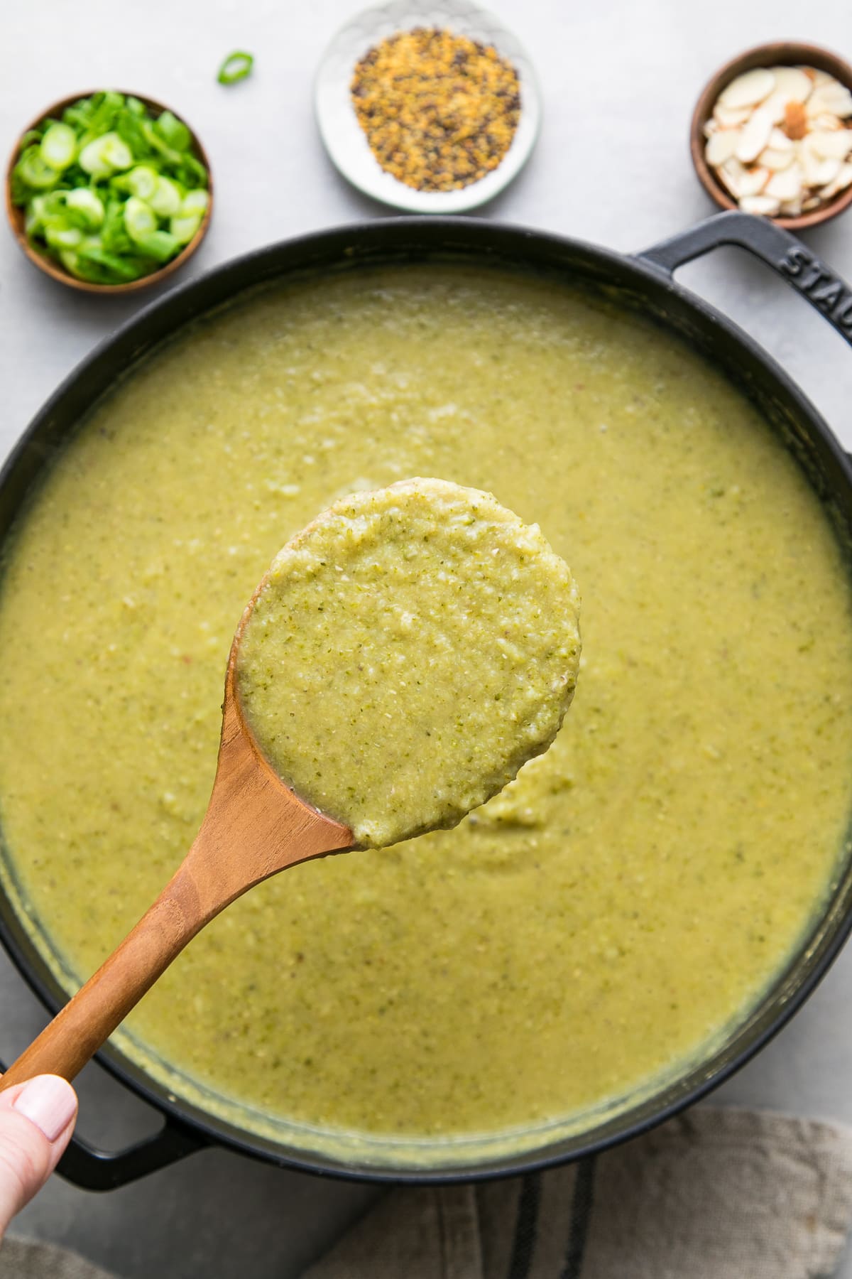 top down view of spoonful of creamy broccoli soup.